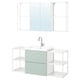 Modern bathroom setup with mint cabinet, white sink, chrome tap, and mirror unit.