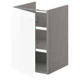Grey ENHET bathroom cabinet with one shelf and a wipe-clean glossy white door, offering organized storage.