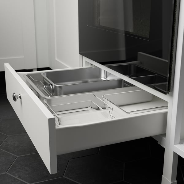 This image shows an open kitchen drawer with multiple compartments for organizing utensils, part of the ENHET series, offering ample storage.