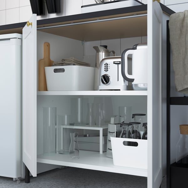 Kitchen cabinet with shelves storing kitchen appliances and glassware.