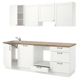 Modern white kitchen set with wooden countertop, stainless sink, and cabinets; minimalist design.
