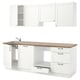 Modern white kitchen set with wooden countertop, stainless sink, and cabinets; minimalist design.