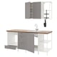 This image the ENHET series kitchen setup with grey cabinets and wooden countertop, including a sink, shelves, and accessories.