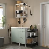 Green ENHET kitchen unit with sink, shelves, drawers, and adjustable light. Compact and efficient storage.