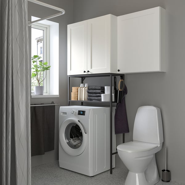 ENHET laundry setup with cabinets, appliances, and decor.
