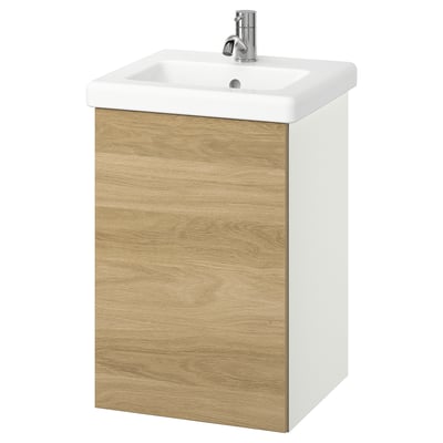 An ENHET bathroom cabinet with a white ceramic sink and oak-effect door. Its wall-mounted, featuring a single drawer.