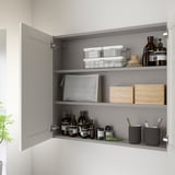 Open wall cabinet with bottles, jars, and containers neatly organized on shelves. Ample storage space for toiletries and bathroom essentials.