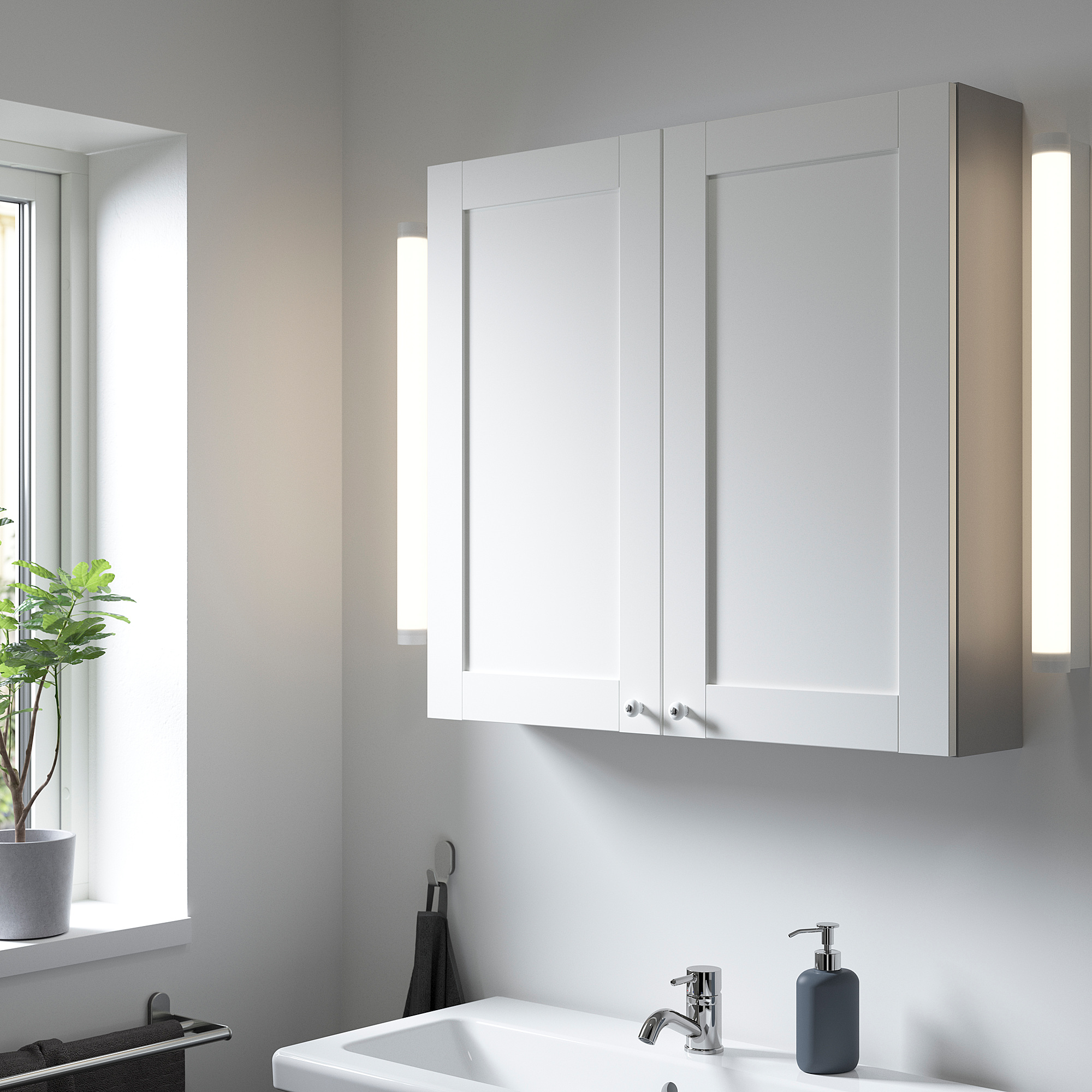 White ENHET wall cabinet with two shelves; modern, clean design, fitting above sink, larger than sink.