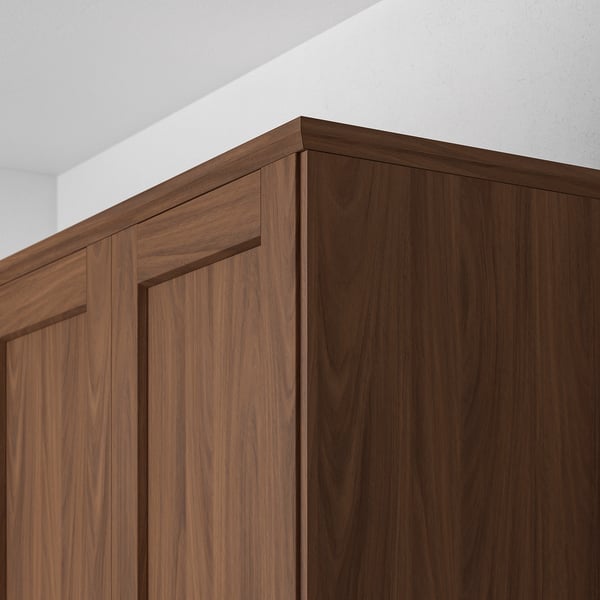 Dark wood cabinet with framed fronts, showing top trim detail.