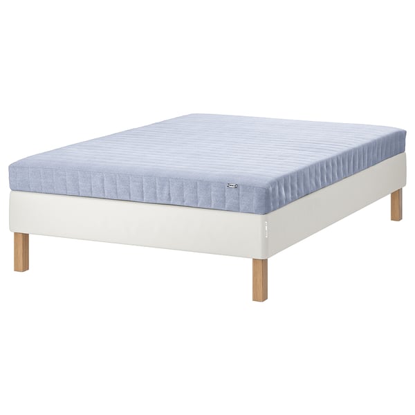 Modern bed with light blue mattress on white wooden base.