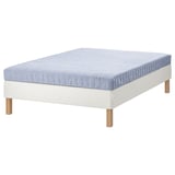 Modern bed with light blue mattress on white wooden base.