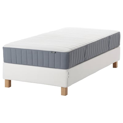 White IKEA mattress set on wooden legs, grey top, rectangular shape.