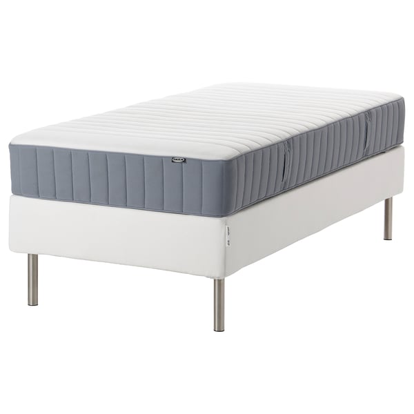 IKEA rolled mattress on bed frame with steel legs, carry handle, pocket springs, cotton-polyester cover.