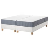 White split beds with blue-gray mattresses, wooden legs, pocket springs.