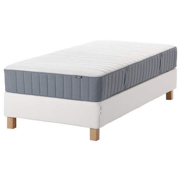 An IKEA white and grey mattresses set with wooden legs.