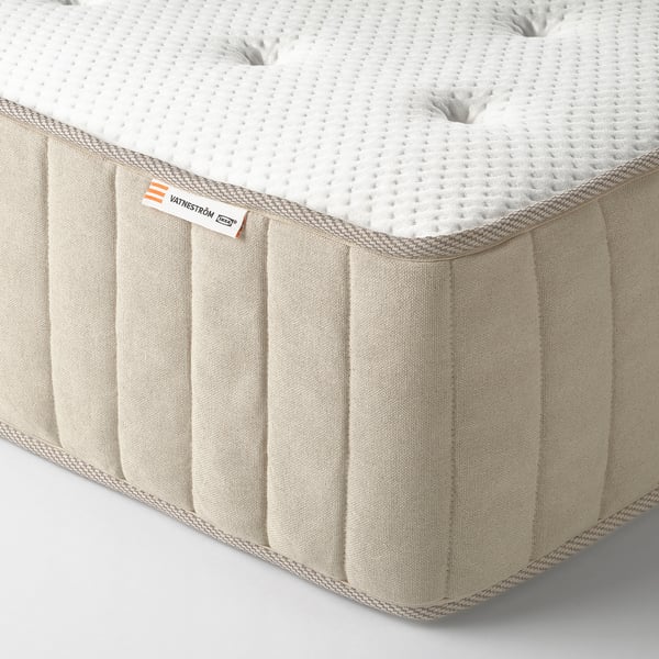 Close-up of a high-quality mattress with visible quilted design and handles, showcasing craftsmanship details.