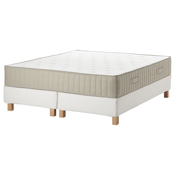 A white mattress and base combo. Simple, square, upholstered with beige detailing.