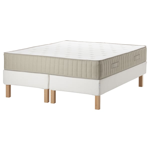 White ESPEVÄR/VATNESTRÖM bed set with beige detailing and wooden legs.