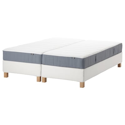 White mattress set, split design, wooden legs, blue sides. Comfortable, adjustable sleep solution.