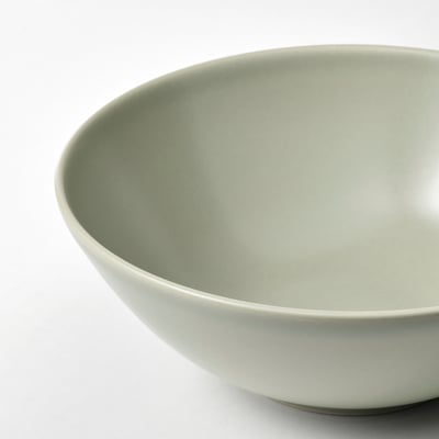 Five light green stoneware bowls, four stacked and one separate, simple modern design.