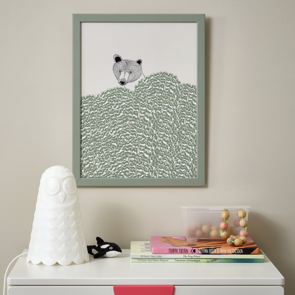 Stylized bear art, owl lamp, whale figurine, books, and container on drawer