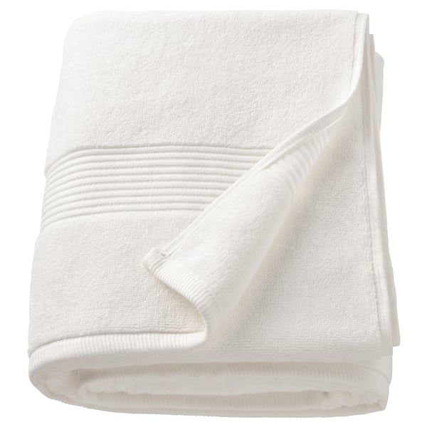 A white FREDRIKSJÖN towel, thick and soft, made of 100% cotton, folded neatly.