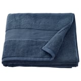 A folded FREDRIKSJÖN towel in dark blue, made of thick, soft cotton with a woven border detail.
