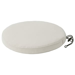 Round white outdoor seat cushion with secure ties.