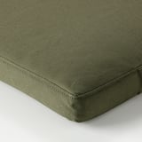 A high-quality, green outdoor cushion with a textured weave, featuring neat stitching and a zipper for easy removal.