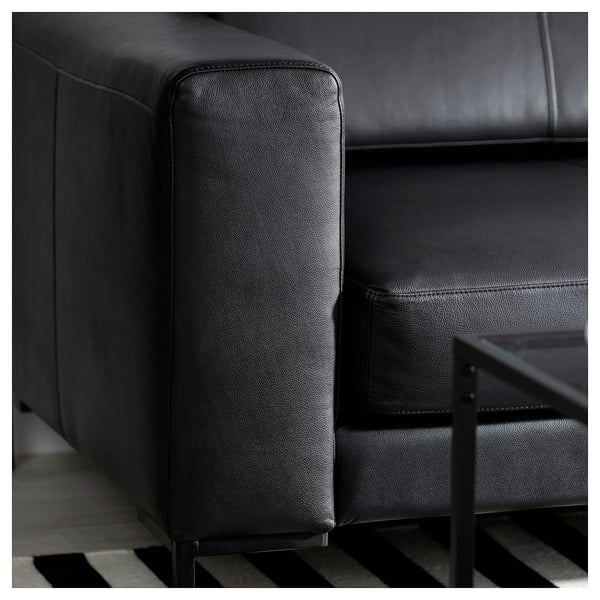 Black leather sectional sofa, modern sleek design, deep seats, metal legs.