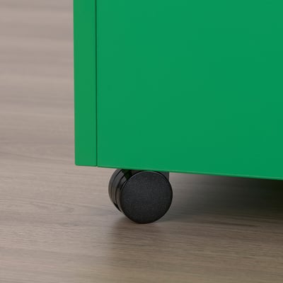 Close-up of green GARNANÄS table leg with black wheel on wooden floor.