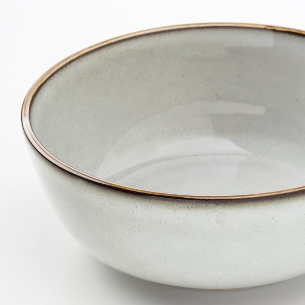 Shallow dish with smooth glaze and dark, thick rim.