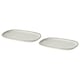 Two white oval GLADELIG plates made of stoneware. They have a simple, elegant design with a sandy glaze finish.