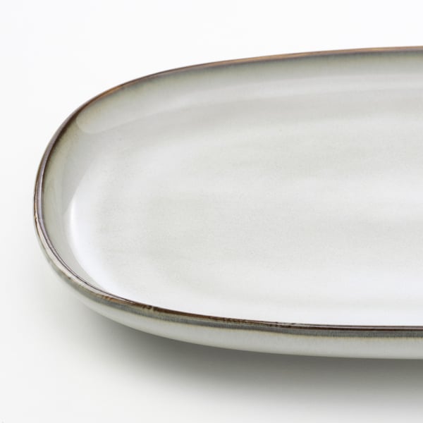 Oval, glazed stoneware serving dish. High-quality, perfect for table settings.