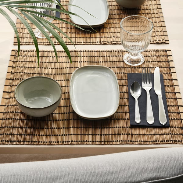 Wilton woven placemat with bowl, plate, glass, and cutlery, arranged neatly.