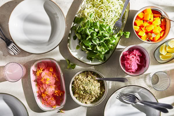 GLADELIG dishes with food on table, utensils & glasses.