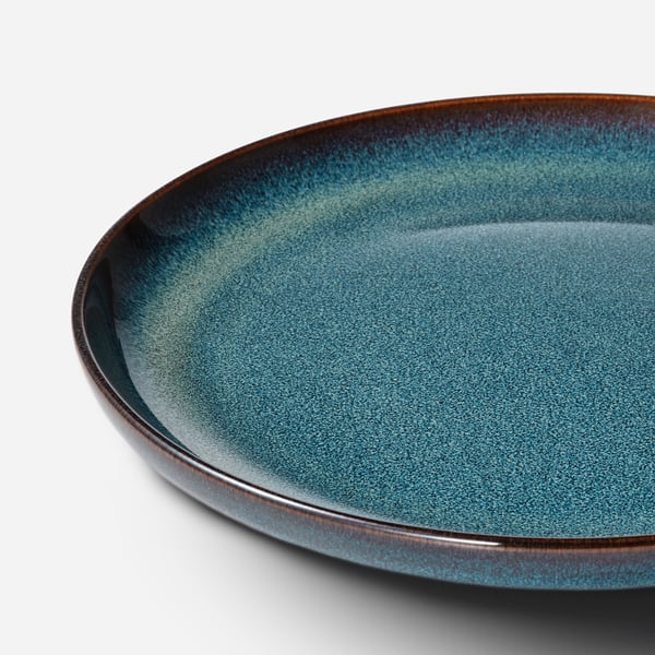 Beautifully crafted deep blue side plate with subtle glaze texture and gold trim.