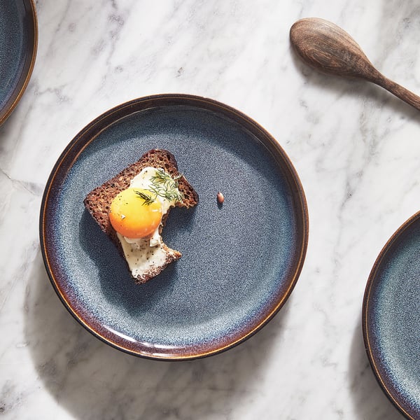 Blue GLADELIG stoneware side plate with food, showcasing classic shape and crafted design.