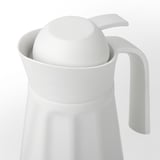 White insulated pitcher with a handle, featuring a removable lid and a curved spout for easy pouring.