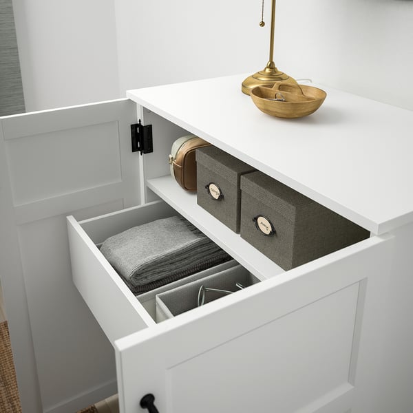 Organized drawer units inside a white cabinet, with labeled sections for neat storage.