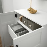 Organized drawer units inside a white cabinet, with labeled sections for neat storage.