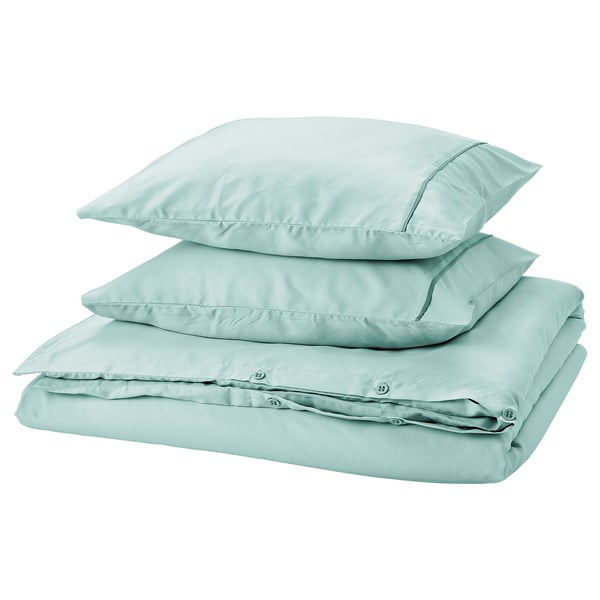 GUCKUSKO duvet set in light turquoise with piping, 100% lyocell, neatly stacked.