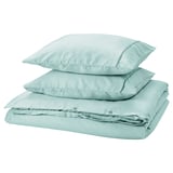 GUCKUSKO duvet set in light turquoise with piping, 100% lyocell, neatly stacked.