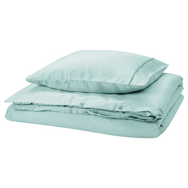 GUCKUSKO duvet set in light turquoise with piping, silky lyocell, folded, rectangular with rounded corners.