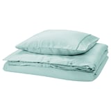 GUCKUSKO duvet set in light turquoise with piping, silky lyocell, folded, rectangular with rounded corners.