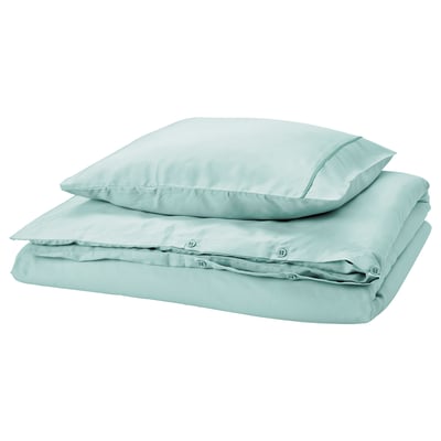 GUCKUSKO duvet set in light turquoise with piping, silky lyocell, folded, rectangular with rounded corners.