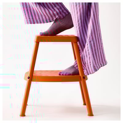 An orange plastic step stool named HADDARP with non-slip surfaces and four legs for stability.