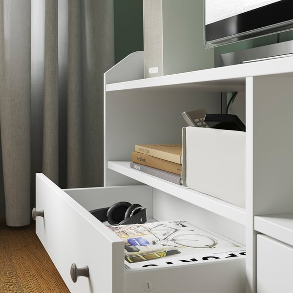 White HAUGA tv unit with drawers, sleek design, and modern finishes. Stores electronic accessories and manages cables effectively.