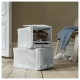 Two white fabric storage boxes stacked, one open displaying tan shoes. Suitable for organizing shoes and items in home.