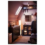 Wooden HEMNES chest with mirror in dark brown room, pink walls, skylight, wicker basket.